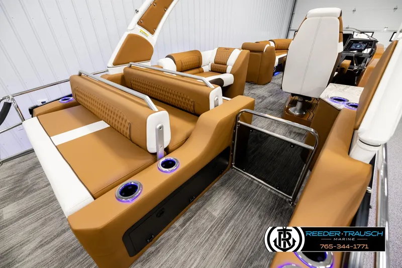 Slide: The Image of Luxurious interior of 2026 Avalon Excalibur LTD FL boat with tan and white seating. - 12