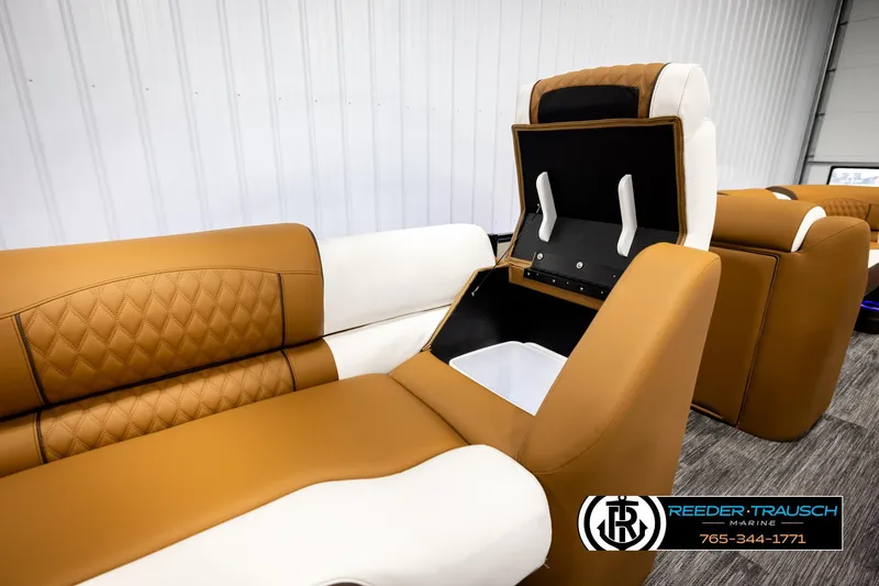 Slide: The Image of Luxurious seating in 2026 Avalon Excalibur LTD FL boat with storage compartment open. - 23
