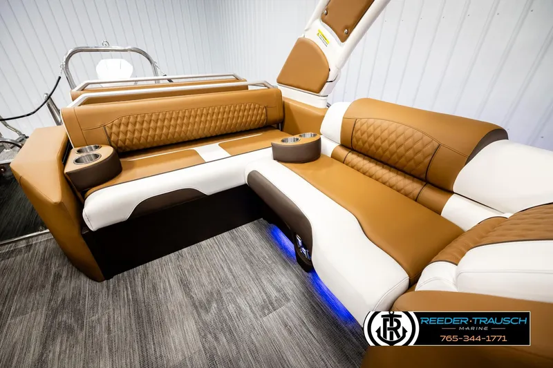 Slide: The Image of Luxurious seating in 2026 Avalon Excalibur LTD FL boat with tan and white upholstery. - 26