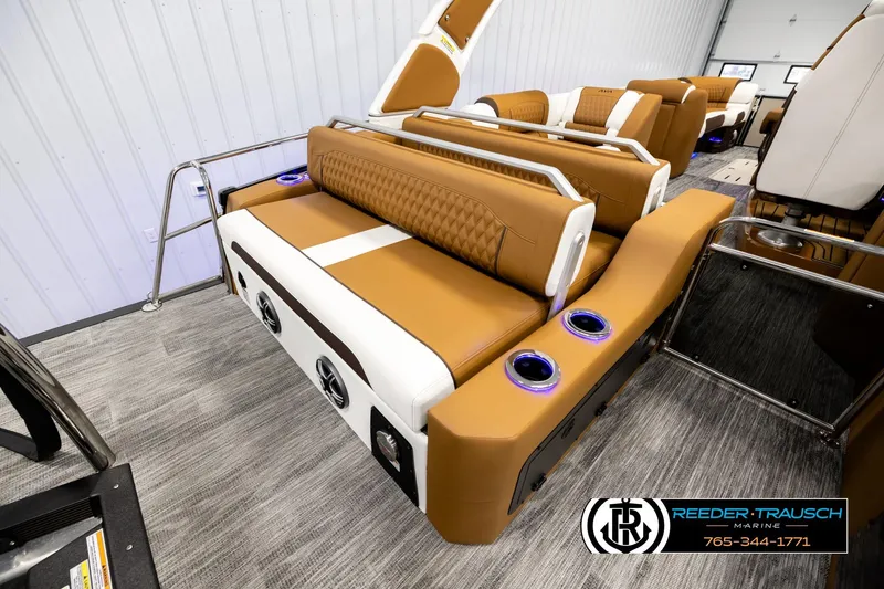 Slide: The Image of Luxurious interior of 2026 Avalon Excalibur LTD FL boat with tan seating and cup holders. - 30