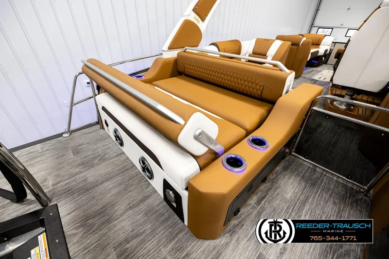 Slide: The Image of Luxurious interior of 2026 Avalon Excalibur LTD FL boat with tan seating and cup holders. - 31
