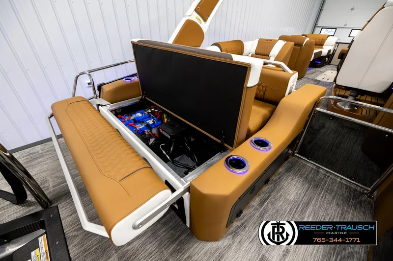 Slide: The Image of Luxurious interior of 2026 Avalon Excalibur LTD FL boat with tan seating and storage compartment. - 34