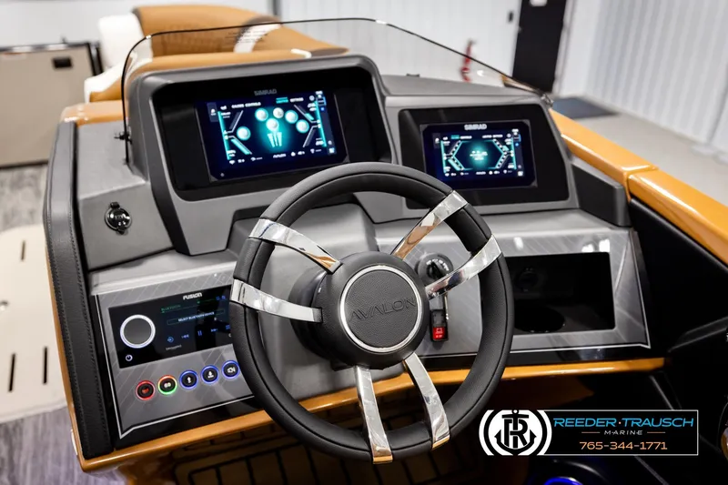Slide: The Image of 2026 Avalon Excalibur LTD FL boat dashboard with advanced digital displays and steering wheel. - 36
