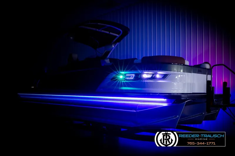 Slide: The Image of 2026 Avalon Excalibur LTD FL boat with vibrant blue and purple LED lights. - 4