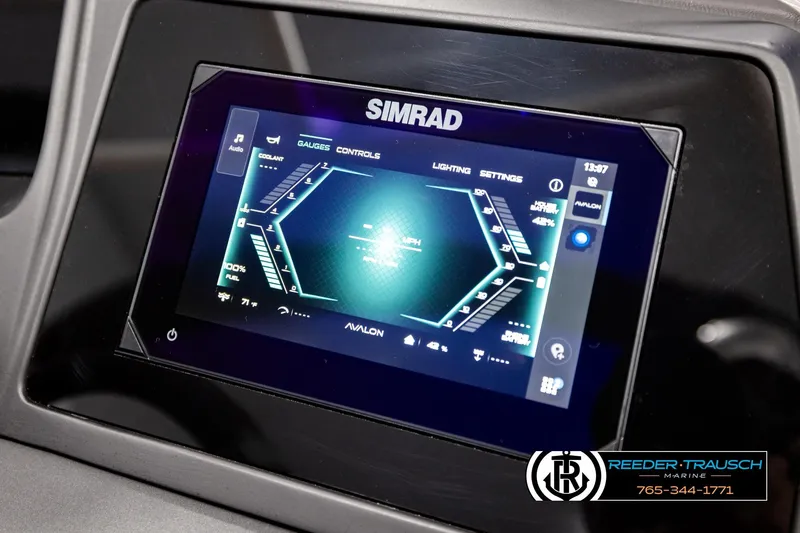 Slide: The Image of 2026 Avalon Excalibur LTD FL dashboard with Simrad display showing gauges and controls. - 40