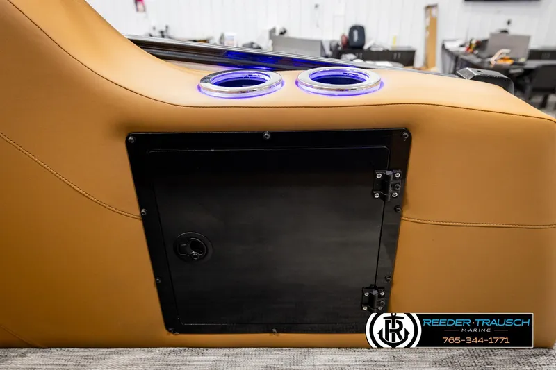 Slide: The Image of 2026 Avalon Excalibur LTD FL boat interior with cup holders and storage compartment. - 46