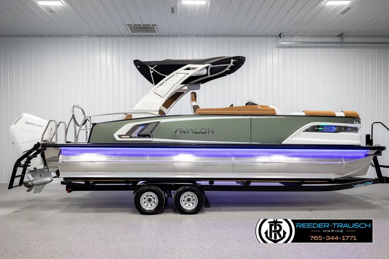 Slide: The Image of 2026 Avalon Excalibur LTD FL pontoon boat with Mercury engine, displayed indoors. - 5