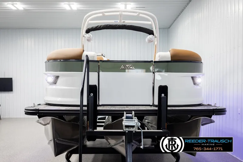 Slide: The Image of 2026 Avalon Excalibur LTD FL boat in showroom, front view with lights on. - 8