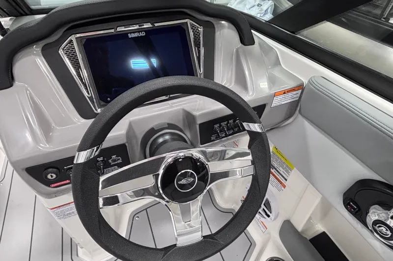 Slide: The Image of 2026 Chaparral 21 SSi boat dashboard with steering wheel and digital display. - 13