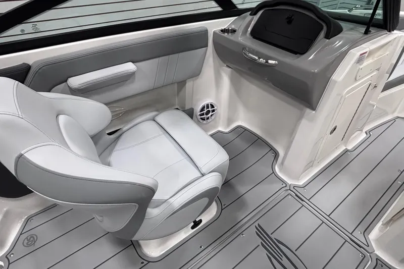 Slide: The Image of 2026 Chaparral 21 SSi boat interior with gray seating and sleek dashboard design. - 21