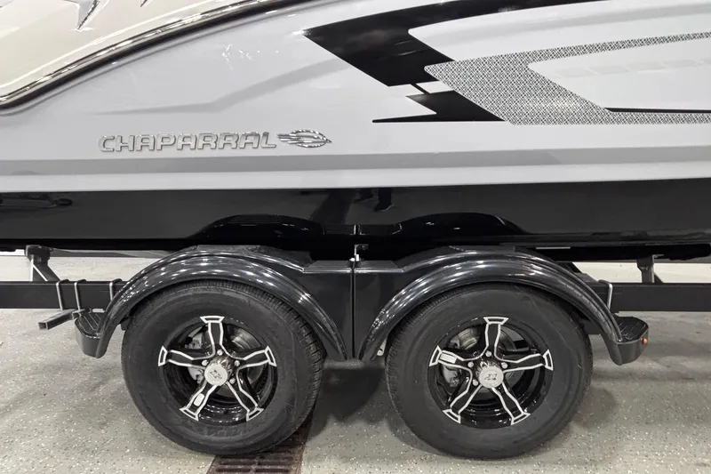 Slide: The Image of 2026 Chaparral 21 SSi boat on trailer with stylish black wheels. - 5