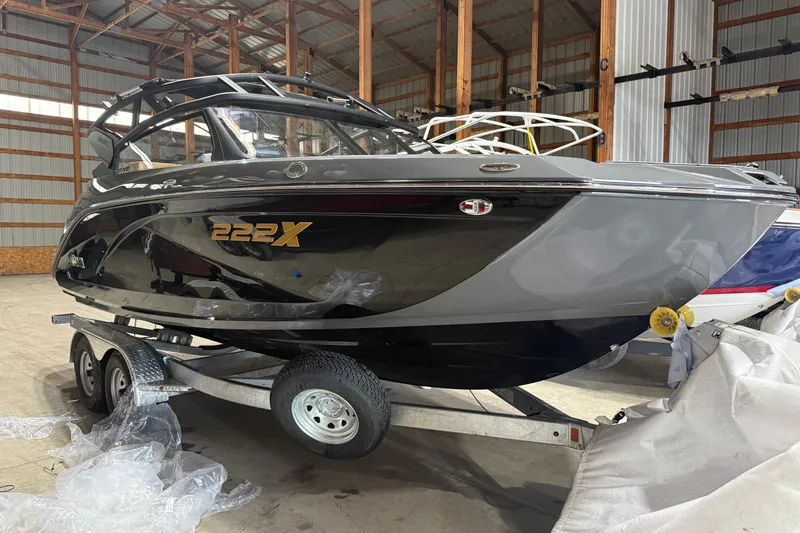 The Image of 2025 Yamaha Boats 222XD in a warehouse, displayed on a trailer. - 0