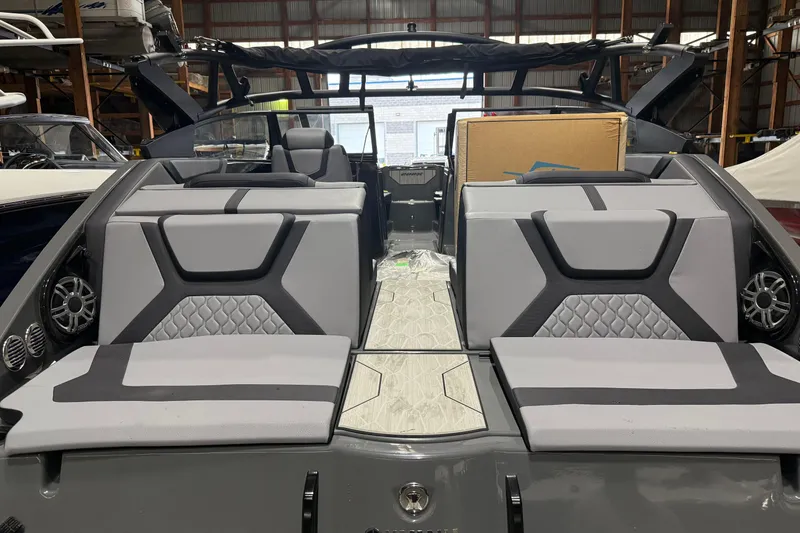 Slide: The Image of 2025 Yamaha Boats 222XD interior with modern seating and sleek design in a warehouse setting. - 3