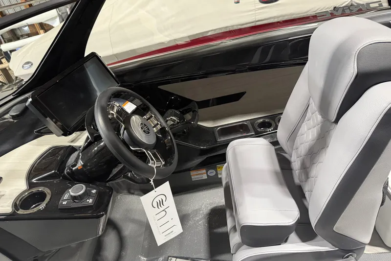 Slide: The Image of Interior of 2025 Yamaha Boats 222XD, featuring sleek steering and modern dashboard. - 5