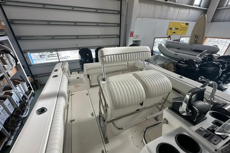 Slide: The Image of 2001 Boston Whaler 26 Outrage boat interior with white seating and control panel. - 10
