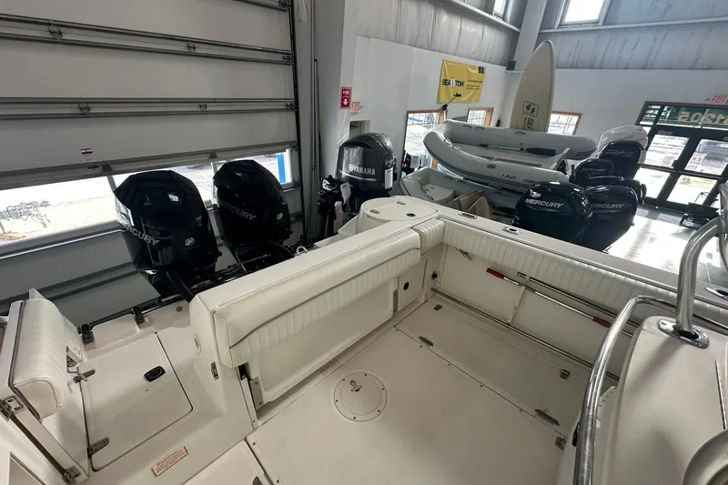 Slide: The Image of 2001 Boston Whaler 26 Outrage boat interior with Mercury engines in showroom. - 11