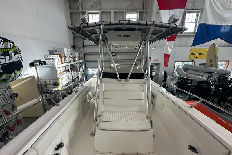 Slide: The Image of 2001 Boston Whaler 26 Outrage boat interior with seating and canopy in showroom. - 14