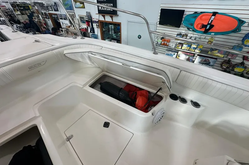 Slide: The Image of 2001 Boston Whaler 26 Outrage boat interior with open storage compartment and marine accessories. - 17