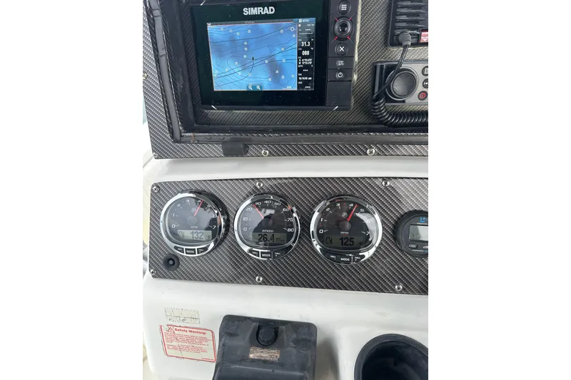 Slide: The Image of Dashboard of a 2001 Boston Whaler 26 Outrage with Simrad navigation system and gauges. - 3