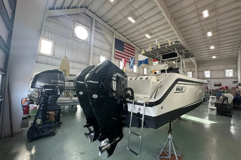 Slide: The Image of 2001 Boston Whaler 26 Outrage boat in a spacious indoor storage facility. - 7