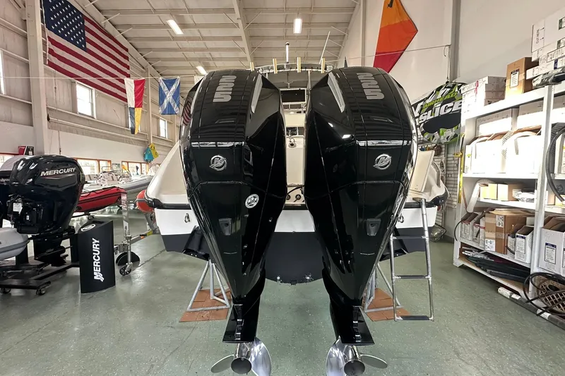 Slide: The Image of 2001 Boston Whaler 26 Outrage with dual Mercury outboard engines in a showroom. - 8