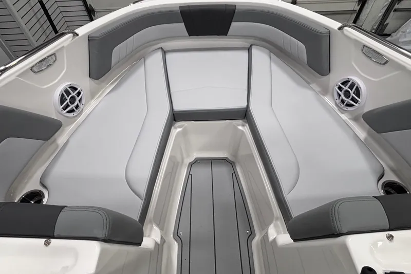 Slide: The Image of 2026 Chaparral 21 SSi boat interior with gray and white seating, featuring built-in speakers. - 15
