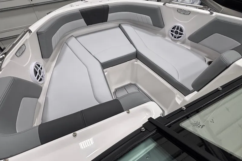 Slide: The Image of 2026 Chaparral 21 SSi boat interior with gray and white seating, featuring built-in speakers. - 16
