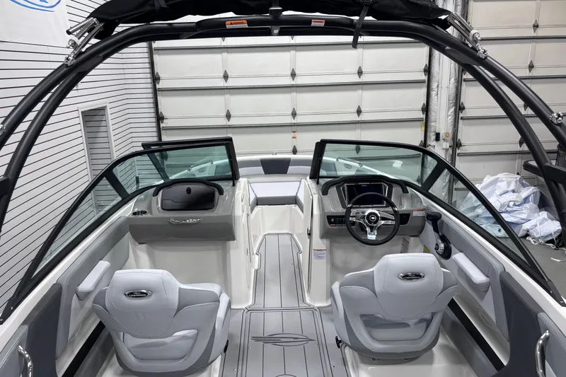 Slide: The Image of Interior view of 2026 Chaparral 21 SSi boat, featuring sleek design and modern controls. - 23
