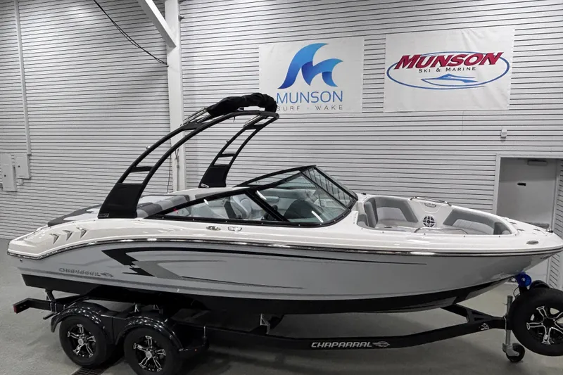 Slide: The Image of 2026 Chaparral 21 SSi boat in showroom, sleek design, Munson Ski & Marine signage. - 8