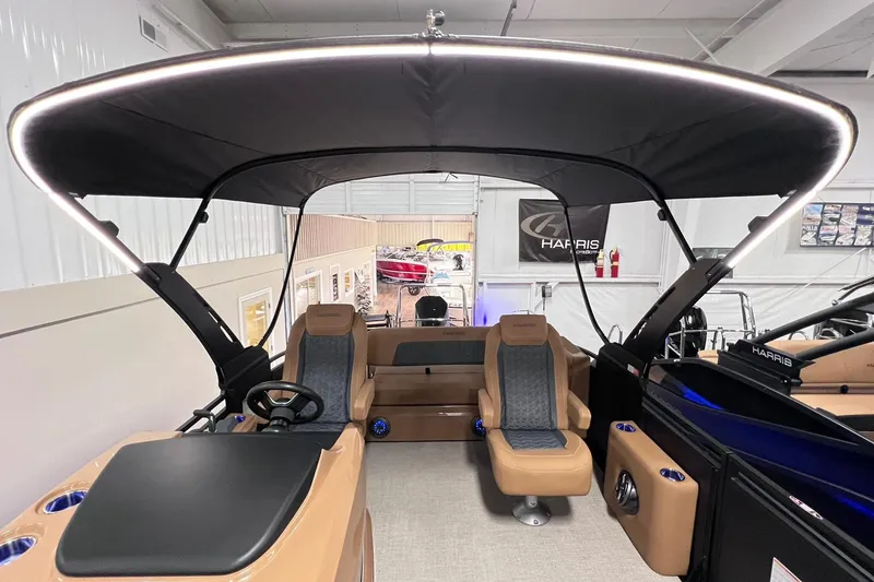 Slide: The Image of 2025 Harris Solstice 230 boat interior with canopy and modern seating. - 2