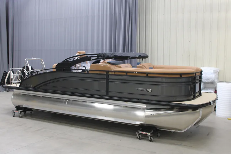 The Image of 2025 Harris Solstice 230 pontoon boat in a showroom, featuring sleek design and luxury seating. - 0