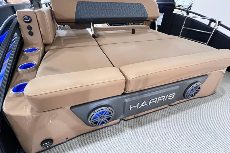 Slide: The Image of 2025 Harris Solstice 230 boat interior with beige seating and integrated speakers. - 7