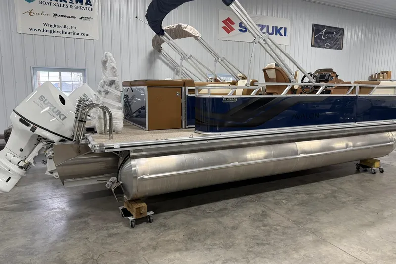 The Image of 2026 Avalon Venture Cruise 21' pontoon boat with Suzuki outboard motor in showroom. - 1