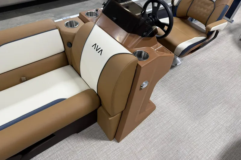 Slide: The Image of 2026 Avalon Venture Cruise 21' boat interior with tan and white seating, steering console. - 16