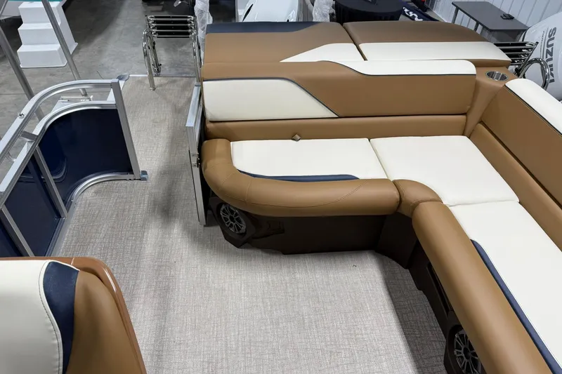 Slide: The Image of 2026 Avalon Venture Cruise 21' boat interior with tan and cream seating. - 18