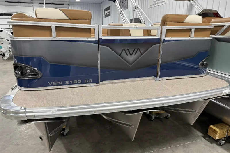 Slide: The Image of 2026 Avalon Venture Cruise 21' pontoon boat, blue and gray design, in showroom. - 4