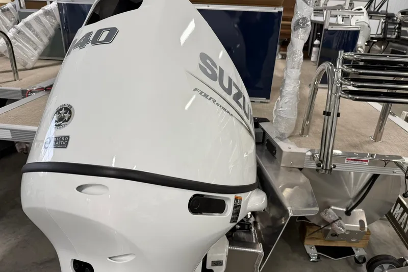 Slide: The Image of 2026 Avalon Venture Cruise 21' with Suzuki outboard motor in showroom. - 5