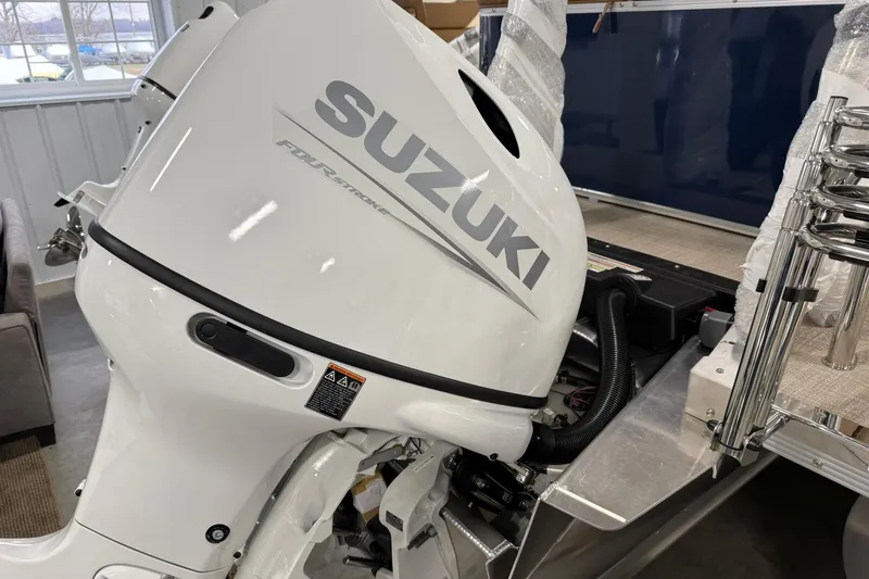 Slide: The Image of 2026 Avalon Venture Cruise 21' with Suzuki four-stroke outboard motor in showroom. - 6