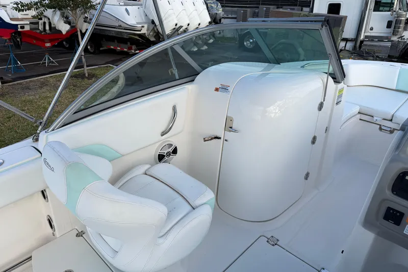 Slide: The Image of 2020 Robalo R207 Dual Console boat interior with white seating and storage compartment. - 7