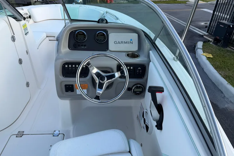 Slide: The Image of 2020 Robalo R207 Dual Console boat dashboard with Garmin navigation system. - 8