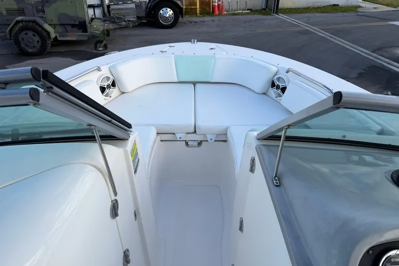 Slide: The Image of 2020 Robalo R207 Dual Console boat interior with white seating and speakers. - 9