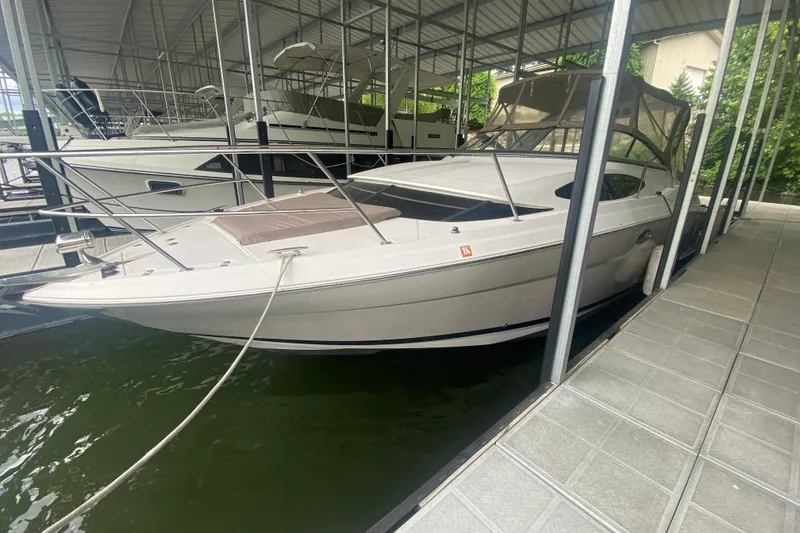The Image of 2008 Regal 3360 Window Express boat docked in a covered marina. - 0