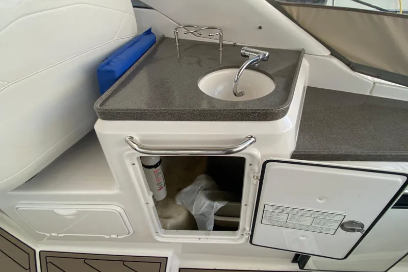 Slide: The Image of 2008 Regal 3360 Window Express boat interior with sink and storage compartments. - 11