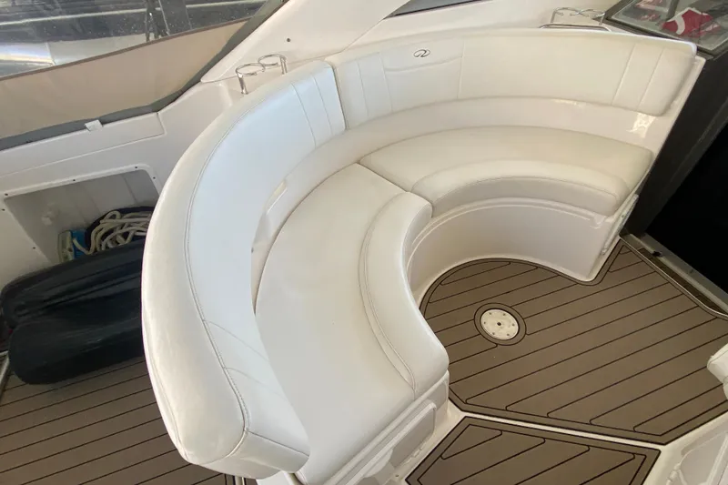 Slide: The Image of 2008 Regal 3360 Window Express boat with white curved seating and teak flooring. - 12