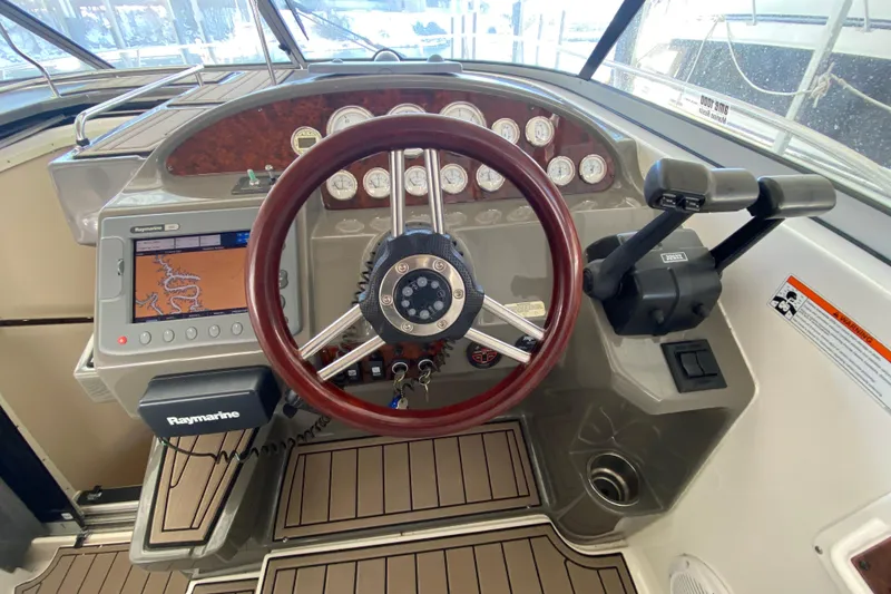 Slide: The Image of 2008 Regal 3360 Window Express helm with Raymarine navigation system and wood-accented steering wheel. - 16
