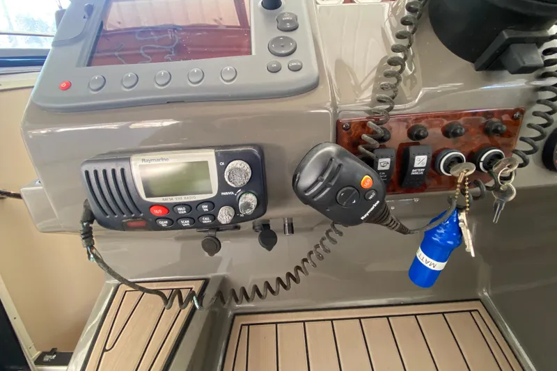 Slide: The Image of Control panel of a 2008 Regal 3360 Window Express boat with radio and keys. - 18