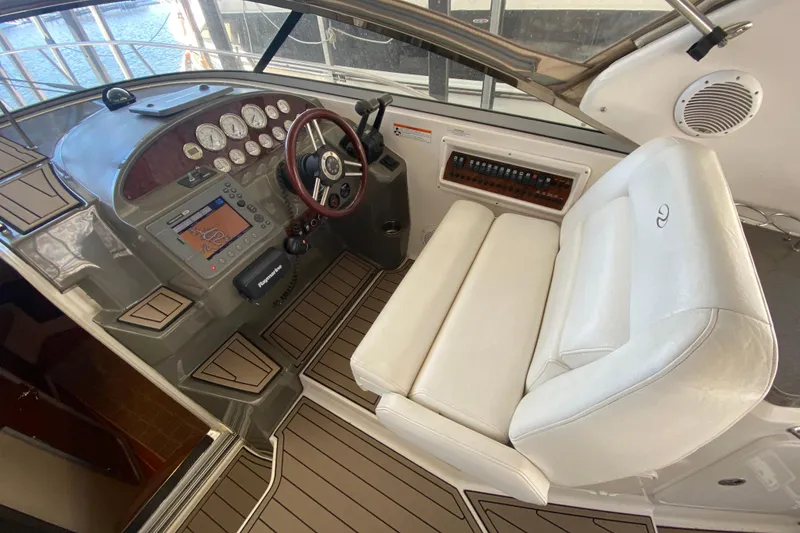 Slide: The Image of 2008 Regal 3360 Window Express helm with white seating and navigation controls. - 19