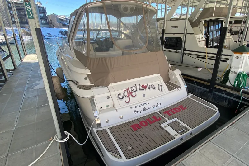 The Image of 2008 Regal 3360 Window Express boat docked, featuring custom "ROLL TIDE" lettering on the deck. - 2