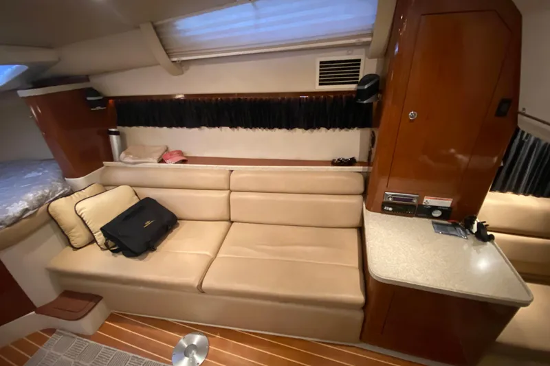 Slide: The Image of 2008 Regal 3360 Window Express interior with beige seating and wooden cabinetry. - 21
