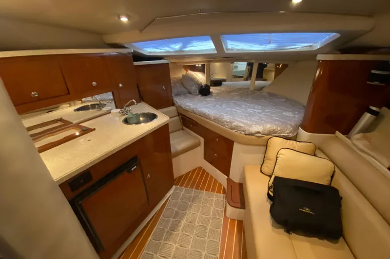 Slide: The Image of 2008 Regal 3360 Window Express cabin interior with kitchenette, bed, and seating area. - 22